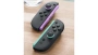 Nintendo Joy-Con 2, светло-фиолетовый и светло-зелёный — контроллеры на столе